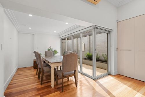 a dining room with a table and some chairs at Stylish 3BR House with parking & ICC&Darling Harbour-8 mins walk in Sydney