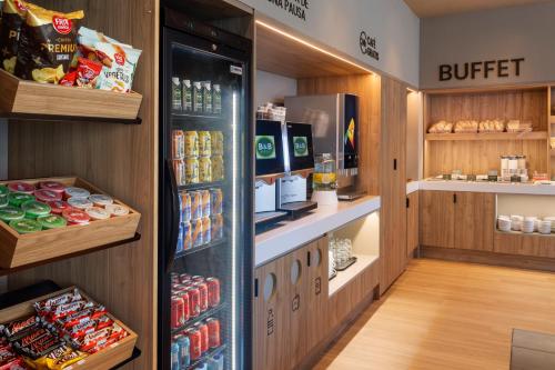 a grocery store aisle with a buffet and drinks at B&B HOTEL Madrid Carabanchel in Madrid