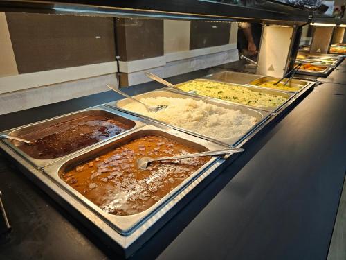 a buffet line with many different types of food at Premier Flat Queimados in Queimados