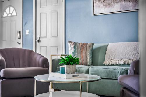 a living room with a couch and a table at Beach Cottage with heated pool just off Siesta Key in Sarasota