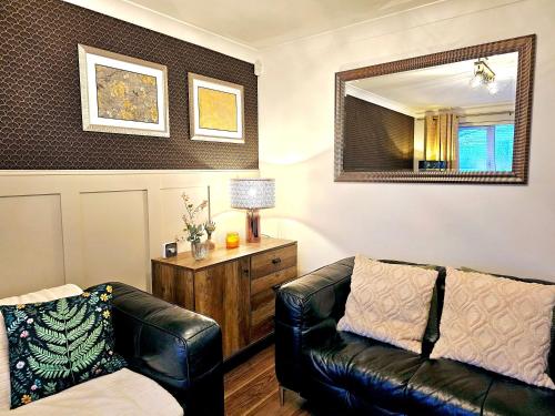 a living room with a couch and a mirror at The Birch homely retreat in Middlesbrough