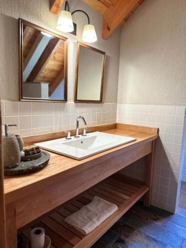 a bathroom with a sink and a mirror at El Pedregoso Cabaña del Lago in Cholila