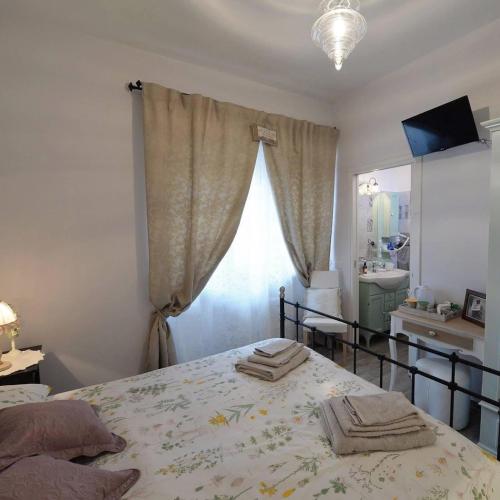 a bedroom with a bed with two towels on it at La Maison Sabina in Passo Corese
