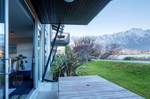 a porch of a house with a view of the mountains at Mantra 2-- Lakeside Walking Track- Free Parking in Queenstown
