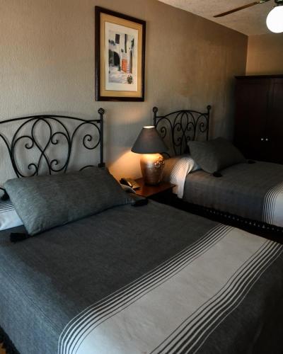 Ein Bett oder Betten in einem Zimmer der Unterkunft Hotel Hacienda