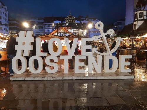 a large white sign that reads the new olympics at Appartement Bootsman prachtig zicht, groot zonnig terras, garage, fietsenberging OOSTENDE FIETSSTAD - ENSORSTAD in Ostend