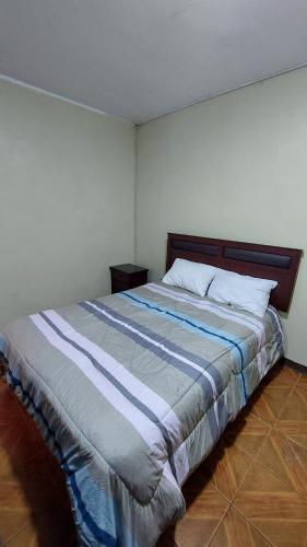 a bedroom with a large bed in a room at Carosvi Home in Lima