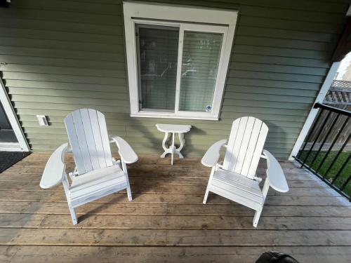 two chairs and a table on a porch at King and Queen rooms -J&J Chilliwack in Chilliwack