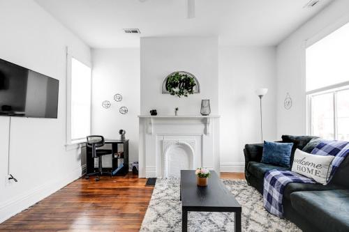 a living room with a couch and a fireplace at Quaint Escape for 2 Near Richmond Battlefield Park in Richmond