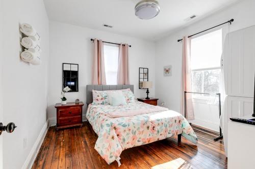 a white bedroom with a bed and a window at Quaint Escape for 2 Near Richmond Battlefield Park in Richmond