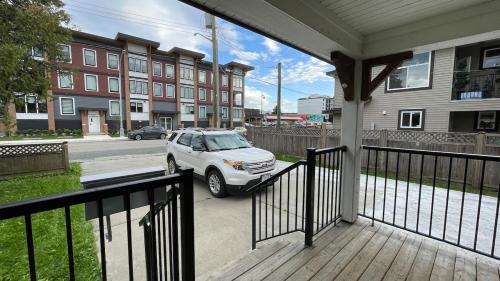 a car parked on a porch of a house at King and Queen rooms -J&J Chilliwack in Chilliwack
