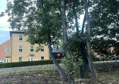 a group of trees in front of a building at Igloo Magnolia Room Stay I Breakfast I Free Parking in Leeds
