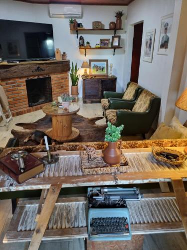 a living room with a couch and a table at Chácara Alci Guedes in São Gabriel