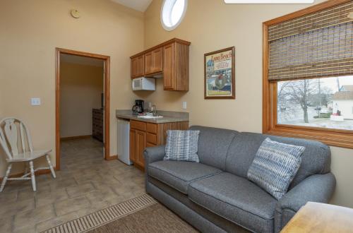a living room with a couch and a kitchen at Bridge Inn in Michigan City