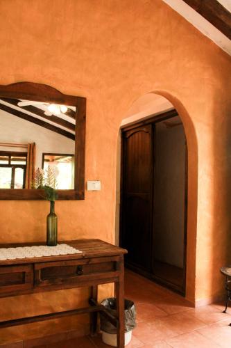 a bathroom with a mirror and a wooden table at Posada La Querencia in Xico