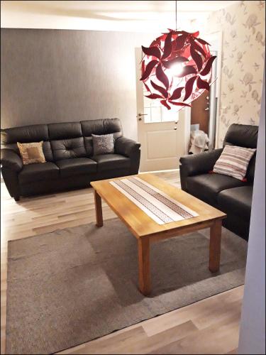 a living room with a couch and a coffee table at Pauliström - Schöne Ferienwohnung für bis zu 4 Personen - 60qm in Pauliström
