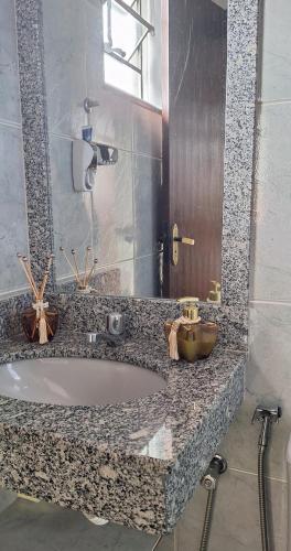 a bathroom with a bath tub and a sink at Aluguel para Temporada in São Roque de Minas
