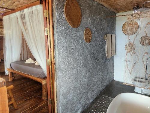 a bathroom with a bed and a tub in a room at Jungle Bar Honeymoon suite & private pool in San Vicente