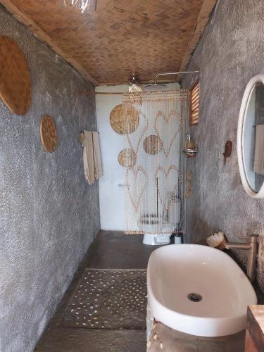 a bathroom with a sink and a toilet in it at Jungle Bar Honeymoon suite & private pool in San Vicente