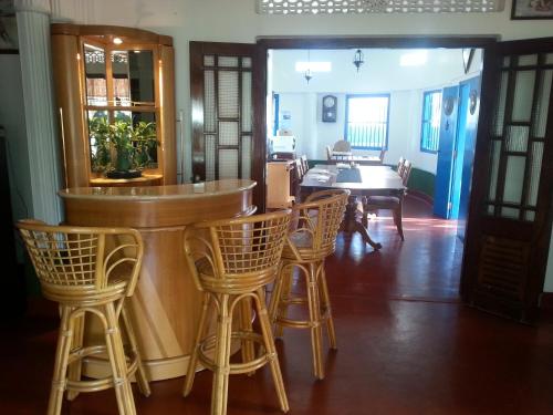 a bar in a room with chairs and a table at Ahangama Eco Villa in Ahangama
