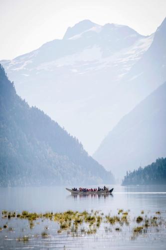 a group of people in a boat on a lake at River Safari Mountain View Suite in Blue River