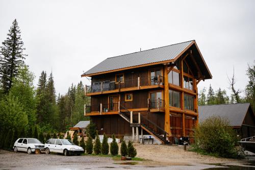 a large house with two cars parked in front of it at River Safari Mountain View Suite in Blue River