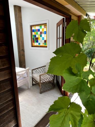 a porch with a bench and a stained glass window at Oma’s Kitchen at Creegans Cottage in Barkers Vale