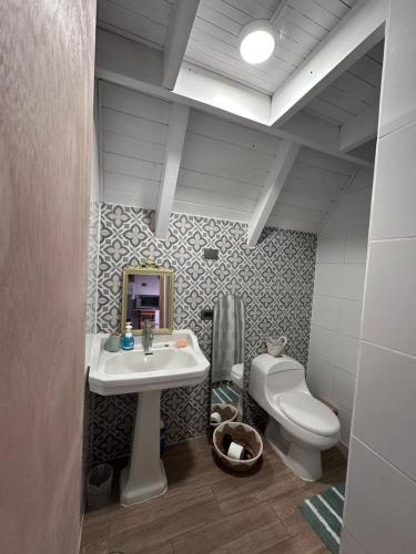 a bathroom with a sink and a toilet at Cabañas RyL2 in Puerto Montt