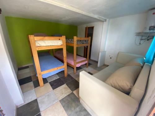 a small room with a bunk bed and a couch at la cinco (5) in Villa Gesell