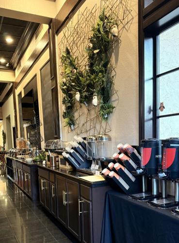 a restaurant with a buffet line with plates and utensils at Hotel Piccadilly in Fresno