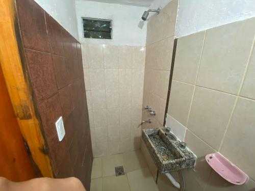 a bathroom with a sink and a toilet at la cinco (5) in Villa Gesell