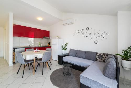 a living room with a couch and a table at Apartments with a parking space Nin, Zadar - 23493 in Nin