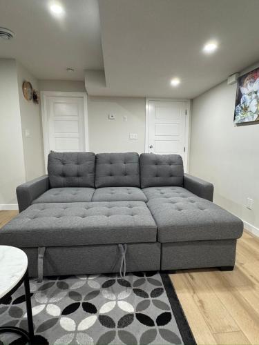a large couch in a living room at DJoshuas place in Edmonton