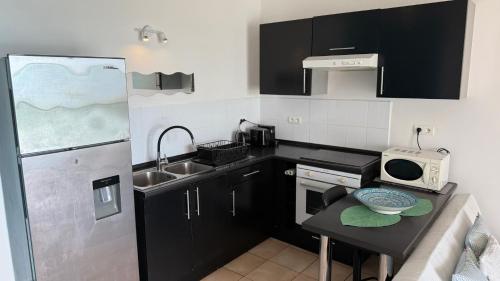 a small kitchen with a sink and a refrigerator at BLUE LAGOON - Terrace View & Beach Access - FREE WIFI PARKING - Bora Bora Dream - SPECIAL OFFER in Bora Bora