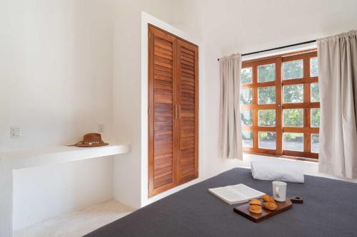 a room with a window and a tray of oranges on a table at Casa Mayali - Walk to Lagoon in Bacalar