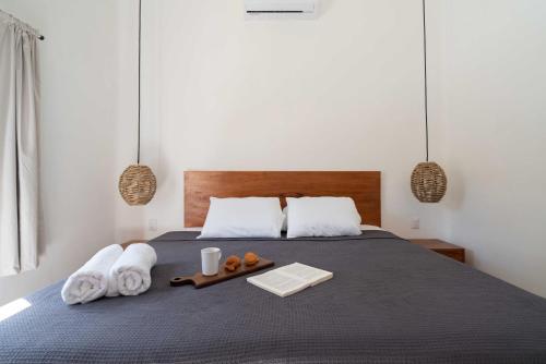 a bedroom with a bed with towels and a tray of food at Casa Mayali - Walk to Lagoon in Bacalar
