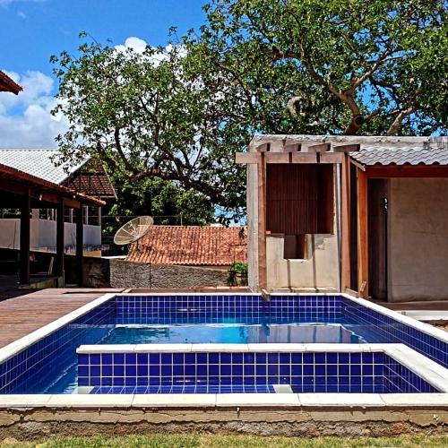a swimming pool in front of a house at Cantinho do Aconchego in Iguaba Grande