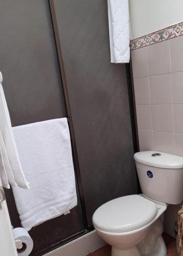 ein Badezimmer mit Toilette und Dusche mit Handtüchern in der Unterkunft Modern, Comfortable, Spacious & Central in Manizales