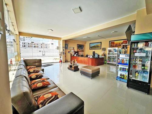 a large room with a couch and a store at hotel el parral suite in Ica