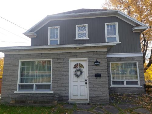 a gray house with a wreath on the door at 930R-B1 The Old House in Quebec City