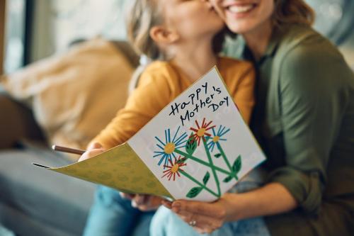 a woman holding a happy new year card with a child at Holiday Inn - the niu, Flower Konstanz by IHG in Konstanz