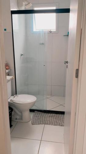 a bathroom with a toilet and a glass shower at Cantinho da day in Aracaju