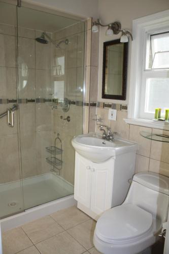a bathroom with a shower and a toilet and a sink at The Classic Horseshoe Bay Motel in Horseshoe Bay