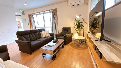 a living room with a couch and a table at Condominium Palace Resort Chatan III in Chatan
