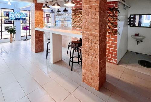 a bar in a store with a brick wall at UrbanView at Balzain East Tuguegarao City by RedDoorz in Tuguegarao City