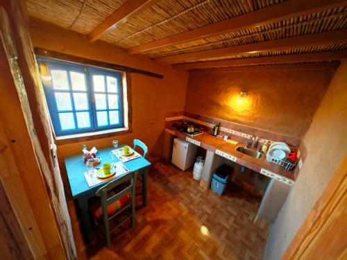 an overhead view of a small kitchen with a table at CkuriQuechuaexperience in San Pedro de Atacama