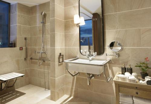 a bathroom with a sink and a shower at Palais de Chine Hotel in Taipei