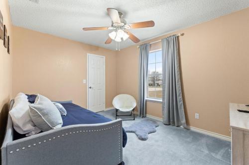 a bedroom with a ceiling fan and a bed and a window at Hackberry Hideaway in Frisco
