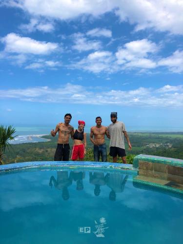 a group of people standing next to a swimming pool at Puerto Alto Hostel in Santa Marta