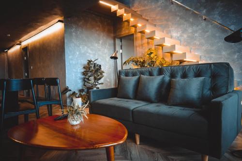 a living room with a couch and a table at Colline Dalat in Da Lat